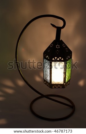 Handcrafted Moroccan lamp with a burning candle inside