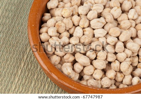Clay pot with fresh organic white chickpeas