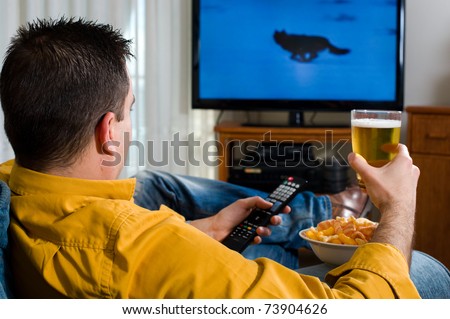 Guy enjoying his evening watching television from the sofa