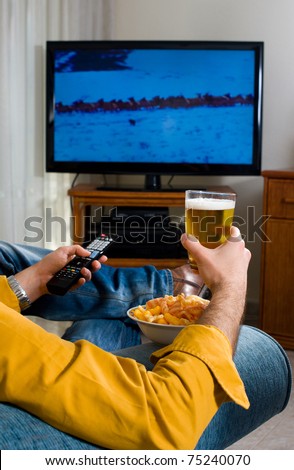 Guy enjoying his evening watching television from the sofa