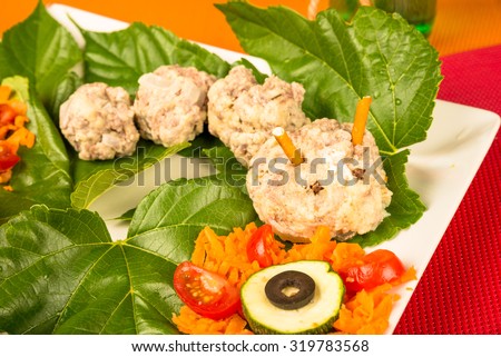 Meatball worm served with vegetables, a creative kid meal