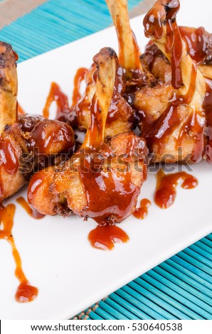 Chicken drumsticks served in BBQ sauce, a creative Spanish tapa