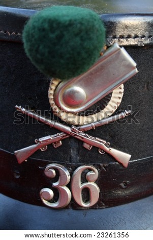 Antique Swiss Army Hat. Close-up of the front of the hat with view of the number 36, crossed rifles and insignia.