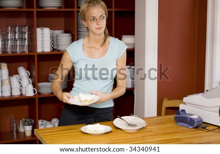 Waitress Holding a Dessert at Cafe Counter