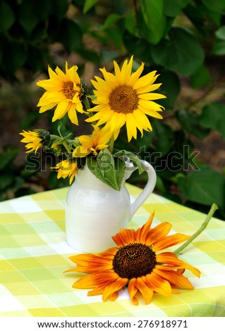 Bouquet of decorative sunflowers in a jug