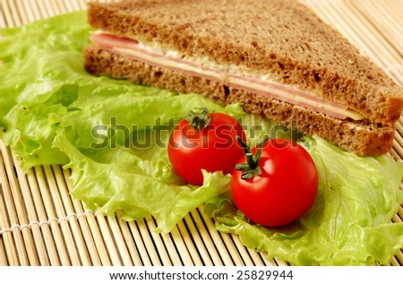 Healthy food: sandwich made with whole grain bread, cheese and bacon,  lettuce and tomatoes