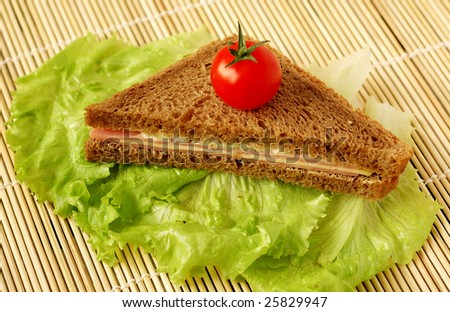 Healthy food: sandwich made with whole grain bread, cheese and bacon,  lettuce and tomato
