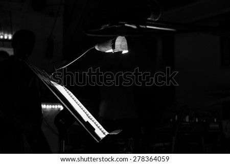 Music note stand with a lighting bulb in a cafe (Black and white tone)