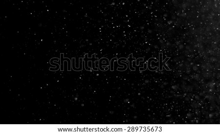 Particle dust floating for filter effect with a dark background.