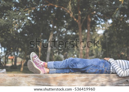 Feet of young girl sleep in the park on nature, Relax time on holiday concept travel , color of hipster tone
