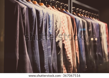 Men suits in a showcase of a clothing shop.