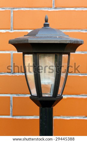 solar garden lamp on background of wall