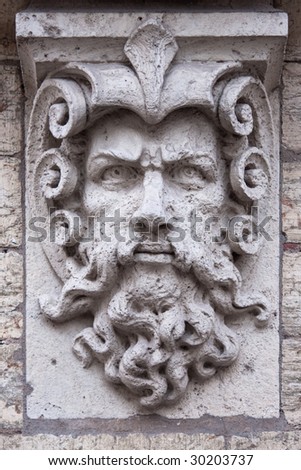 Face of a man with beard, stone sculpture