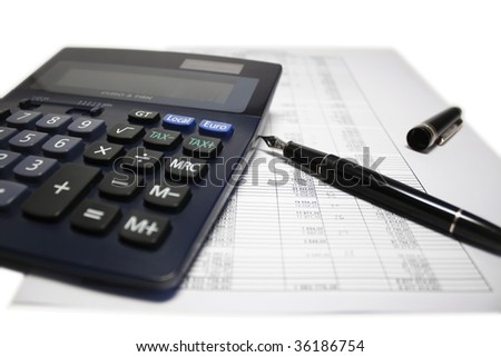 Digital calculator and fountain ink pen lying on balance sheet. Shallow DOF. Focus on tax button.