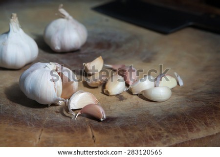 Still life, Lowkey of organic garlic on wooden chopping block, Thai Kitchen Style