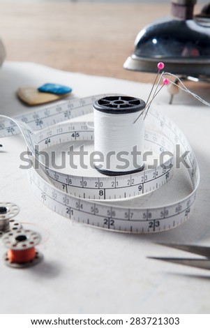Still life of set for needlework,Sewing kit. Scissors, bobbins with thread, measure tape, Iron and needles, Vintage style.