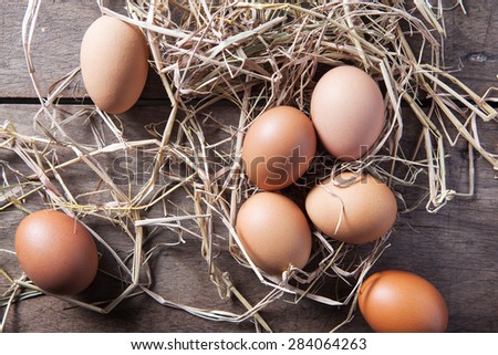 Fresh eggs on rice straw at country farm, Top view, Still life
