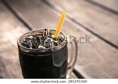 Thai vintage style Iced Black Coffee on wooden background