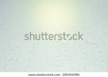 Drops of rain on sweet color glass background with sun light, Soft focus