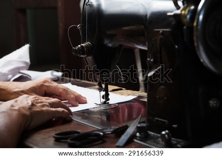 Sewing Process, Antique Sewing Machine with sewer, Lowkey lighting, Focus at needle