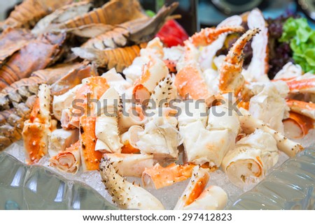 Seafood buffet line Alaska King Crab and mantis shrimp in hotel restaurant, Focus at king crab