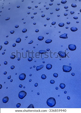 Waterdrops on blue car bonnet
