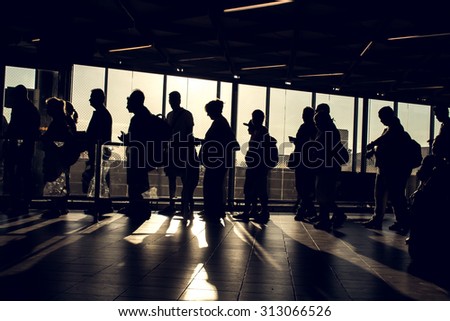 Istanbul, Turkey, August 27, 2015: People are waiting in the Ataturk airport terminal with their silhouette reverse lighted image