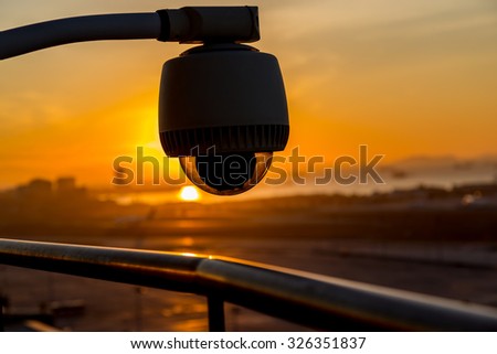 CCTV Security Camera Silhouette with reverse light and sky during the sunrise