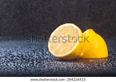 lemon background black blue drops spray