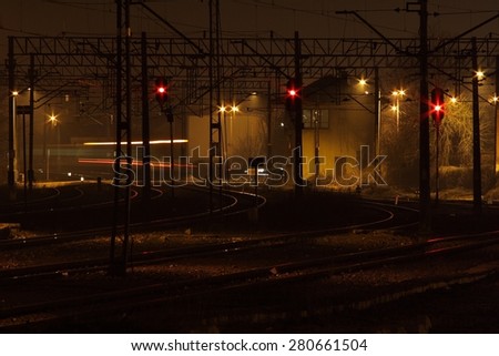 railway platform illuminated at night, building rail, railroad tracks, spotlight