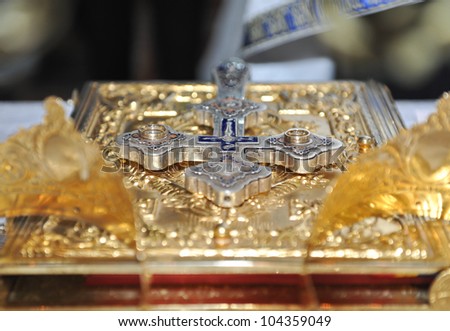 crosses , rings and crowns of gold on the table in church.Wedding celebration