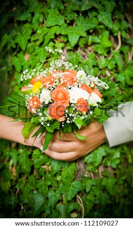 Beautiful wedding bouquet with hands