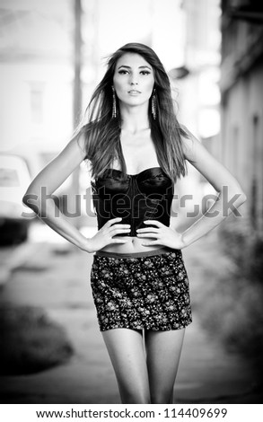 Fashion woman posing on the street. Black and white concept.Black and white photo of sexy girl