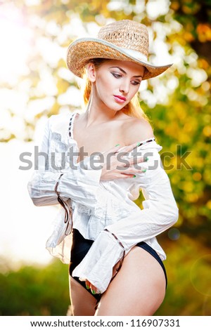 fashion portrait woman with hat and white shirt in the autumn day.Very cute blond woman outdoor  with a hat in a autumn forest