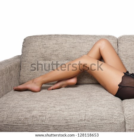 Long Woman legs in stockings on sofa. sexy women legs on sofa .