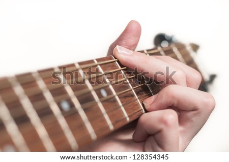 Female hand playing acoustic guitar.guitar play.Close up of guitarist hand playing acoustic guitar