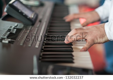 Musician playing on keyboards.Hands playing