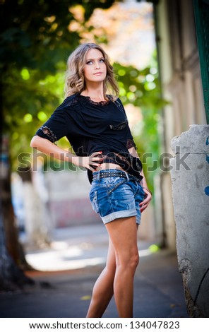 girl in shorts and high heels.fashion urban portrait of beautiful model on the street. fashionable woman posing outdoor in the city
