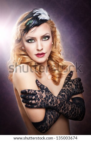 Closeup portrait of a topless blonde woman wearing black lace gloves.Fashionable portrait of the long blond-haired girl with long gloves.Portrait of beautiful topless fashion model with long hair