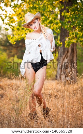 fashion portrait woman with hat and white shirt in the autumn day.Very cute blond woman outdoor with a hat in a autumn forest.Young sensual blonde girl