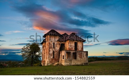 Old abandoned haunted house and sky in Transylvania with clouds.Abandoned mansion in ruins .