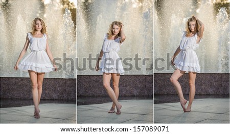 Attractive girl in white short dress sitting in front of a fountain in the summer hottest day. Girl with dress partly wet dancing. Beautiful blonde women near the fountain in a ballet position