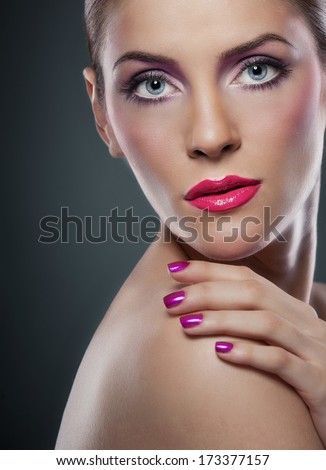 Professional make up - beautiful female art portrait with beautiful eyes. Elegance. Genuine natural woman in studio. Portrait of a attractive woman with red lips and creative make up