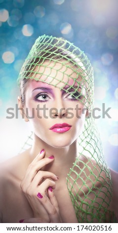 Professional make up - beautiful female art portrait with beautiful eyes. Elegance. Genuine natural woman with veil in studio. Portrait of a attractive woman with red lips and creative make up
