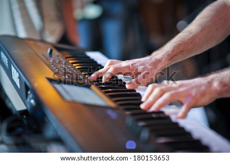 closeup shot of male hands playing the piano .Human hands playing the piano on the party . Man playing the synthesizer keyboard