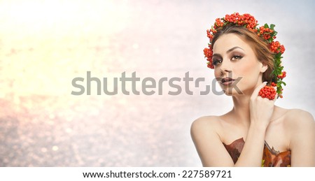 Autumnal woman. Beautiful creative makeup and hair style in fall concept studio shot. Beauty fashion model girl with autumnal make up and hair style. Fall. Creative Autumn makeup. Gorgeous redhead.