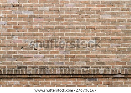 Tan and red brick wall, will horizontal ledge