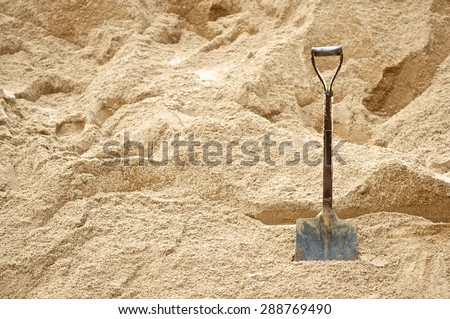 Construction site with shovels on pile of dry soil and sand for background with text. Architecture project. Close up.