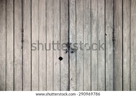 Old wood vintage door background with vignette. Front view of bolt door. Close up.