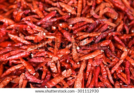 Dried chili peppers background. Many red hot pigments chile wallpaper, the combined or pile. Thai food seasoning. Close up and macro.